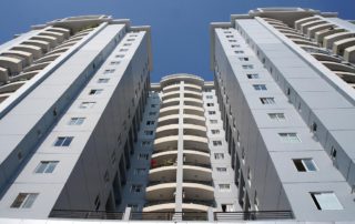Ground view photo of a Florida condo, looking up at the building on a clear day.