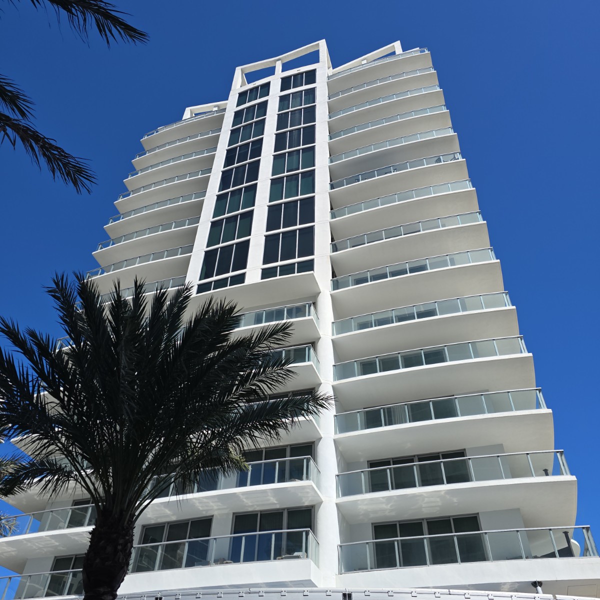 Ground-up view of the condomium complex on a clear, sunny day.