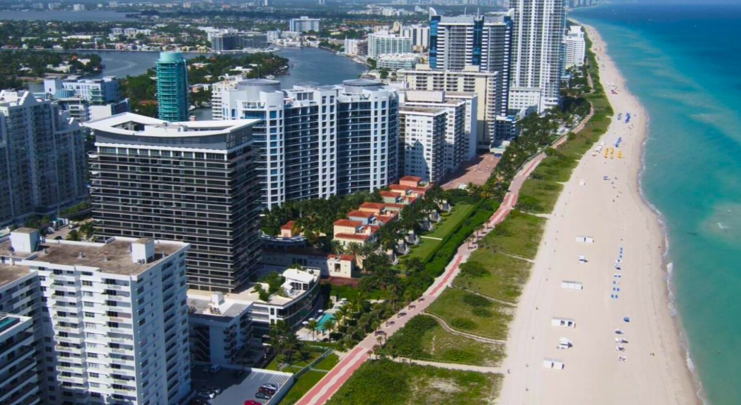 Aerial view of a south Forida beach with several condos.