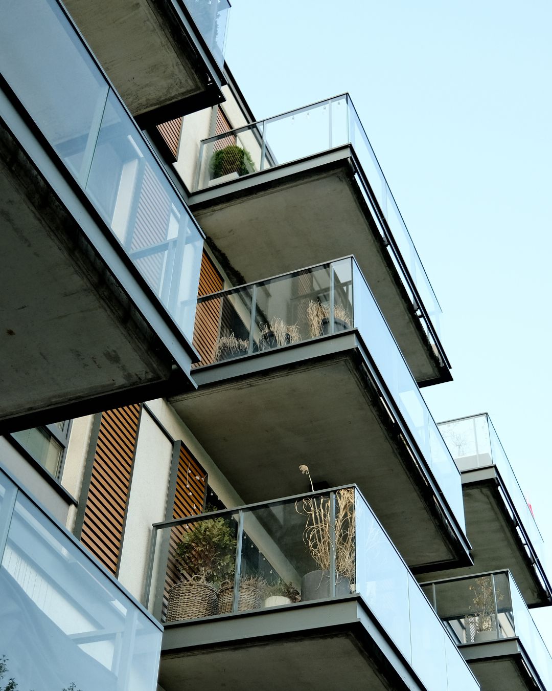 Ground view looking up of several balconies at a South Florida condo.
