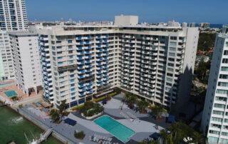 Florida condo building with waterfront pool requiring milestone inspection compliance.