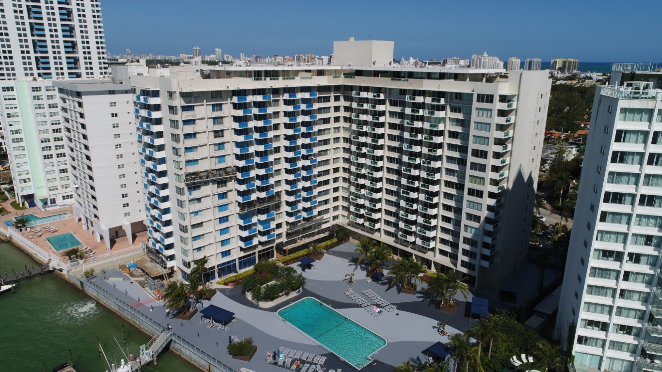 Florida condo building with waterfront pool requiring milestone inspection compliance.