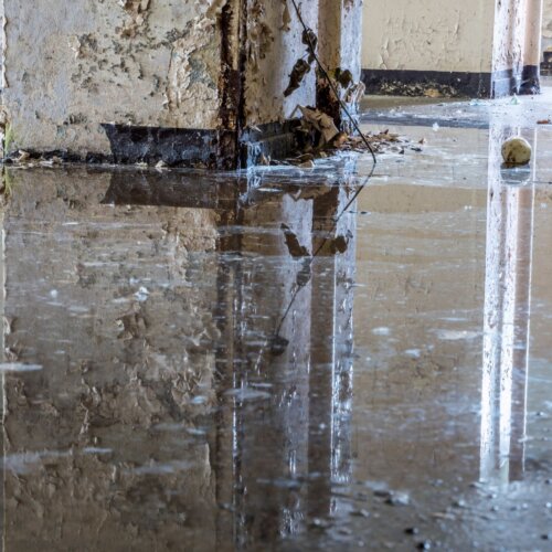 Water damage and flooding inside a South Florida condo building after a hurricane.