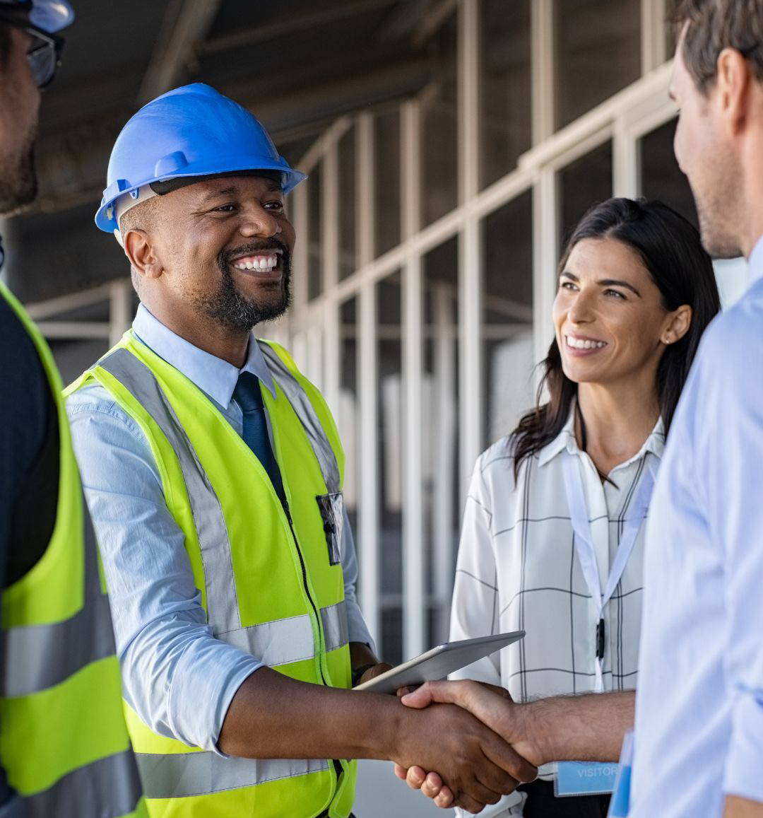 engineering-expertise-building-mavens-v2 A Building Mavens engineer in a blue hard hat shakes hands with a client.